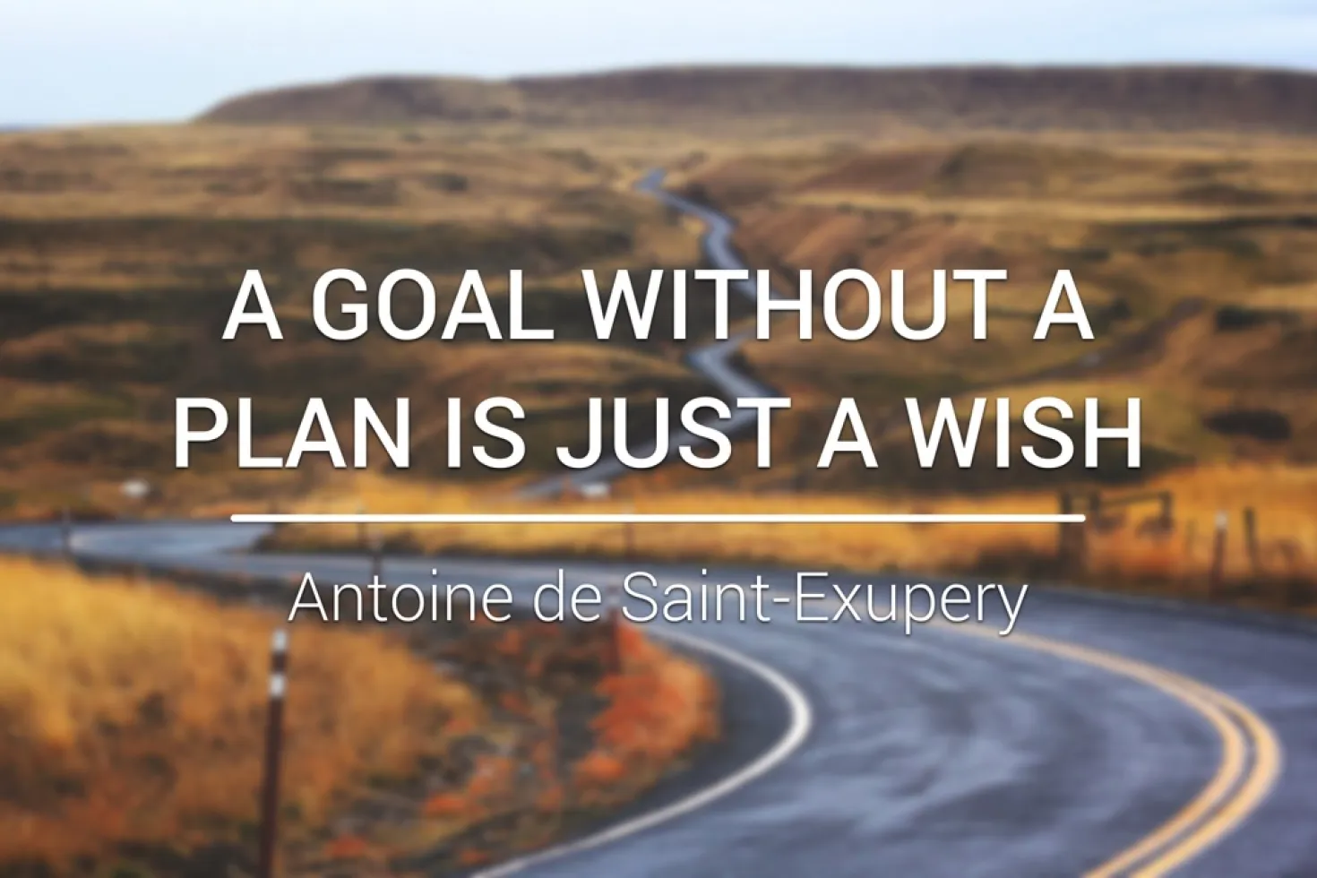 A windy road photo with a quote by St Exupery