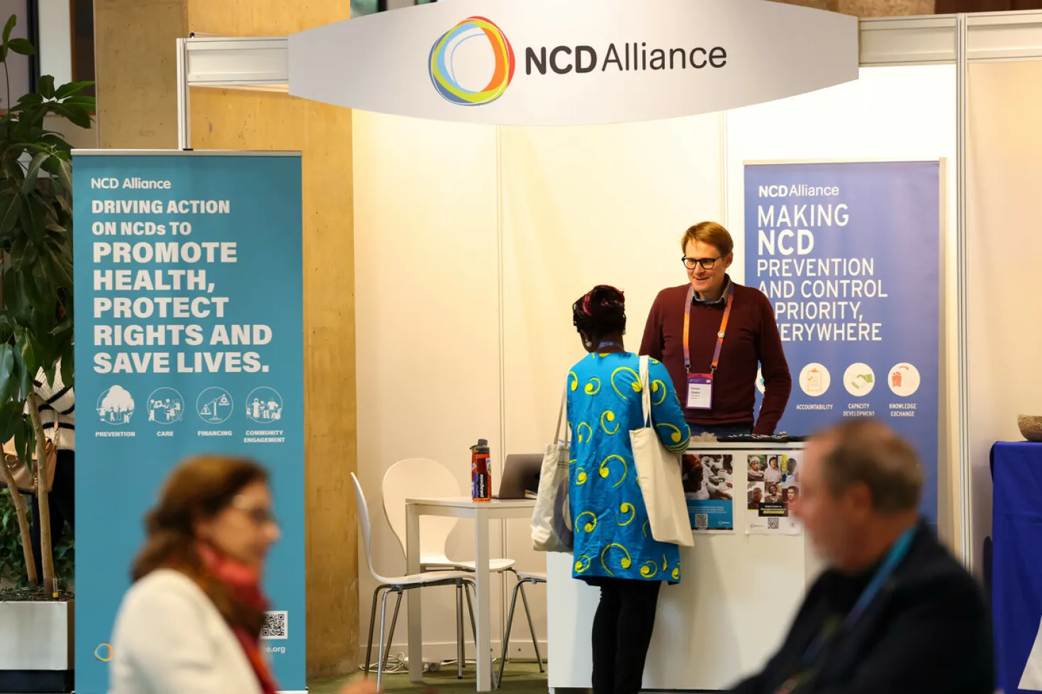 People speaking at a NCD Alliance stand
