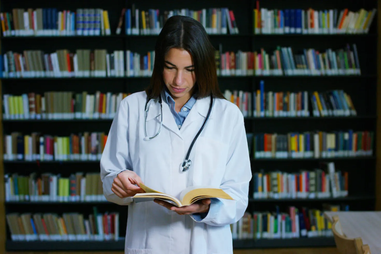 Doctor reading in library Doctor reading in library