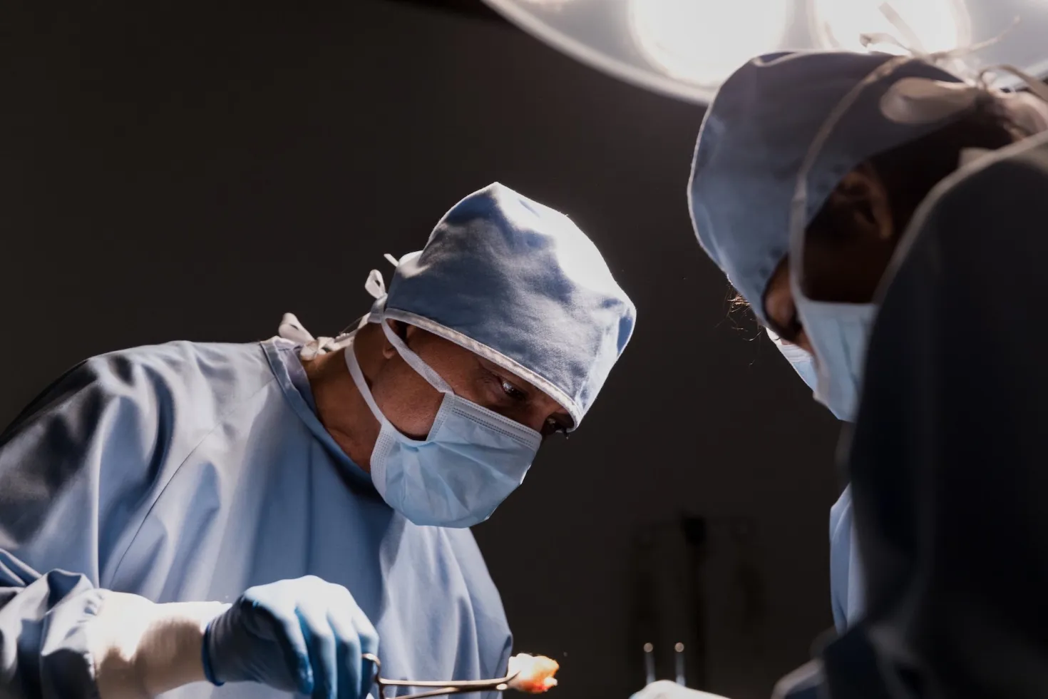 Image shows surgeon at work, emphasising the importance of comprehensive healthcare on in cancer control Image shows surgeon at work, emphasising the importance of comprehensive healthcare on in cancer control