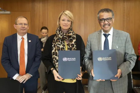 Cary Adams, CEO of UICC, with Katie Dain, CEO of NCDA and Dr TedrTedros Adhanom Ghebreyesus, Director-General of WHO, holding up the MoU formalising relations between NCDA and WHO in 2020
