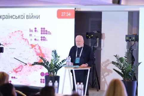 Older man speaking at a podium