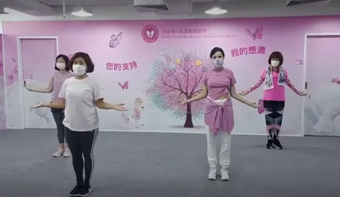 asian women doing a virtual fitness exercise session for breast cancer awareness month. asian women doing a virtual fitness exercise session for breast cancer awareness month.