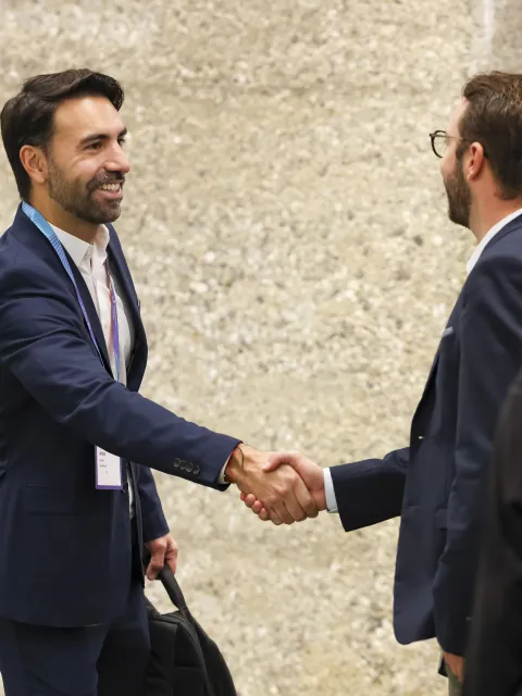 Two men shaking hands and smiling