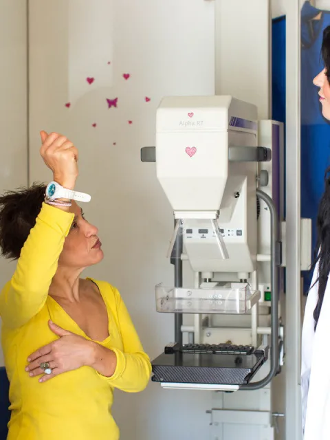 Doctor and patient at the Hellenic Cancer Society demonstrating self-exam